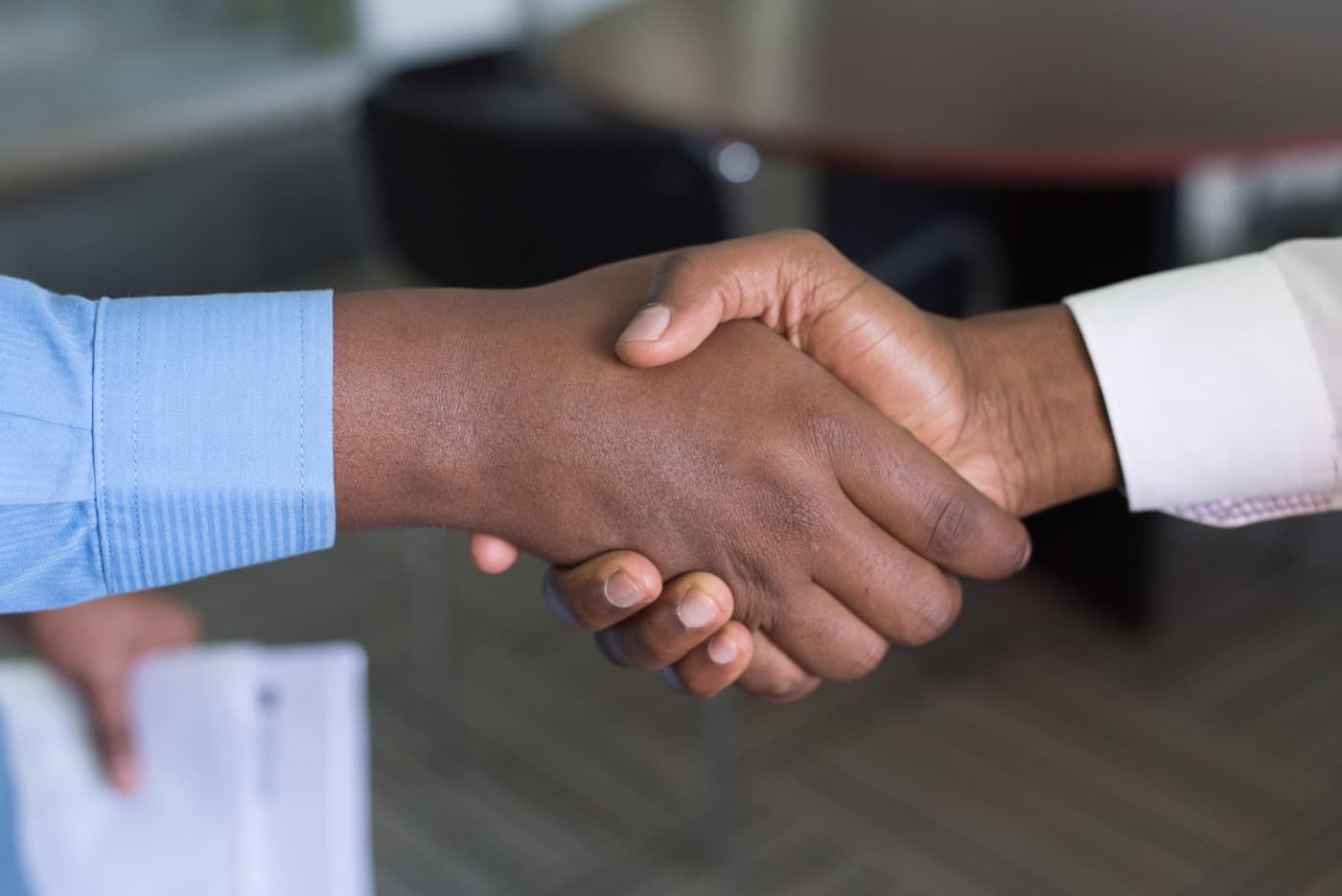 Business partners shaking hands in an East African office